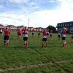 The Junior team going through their warm up ahead of the game.